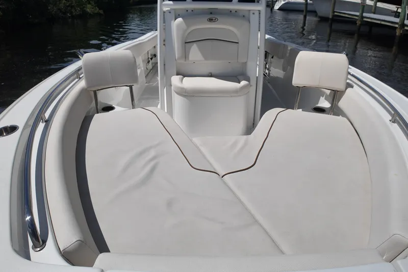 Slide: The Image of 2021 Sea Hunt Ultra 234 boat interior with cushioned seating and sleek design. - 18