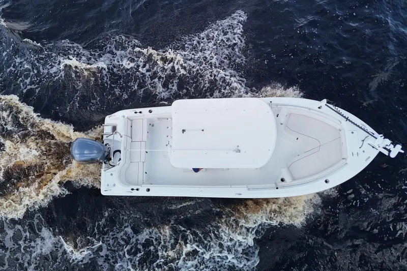 Slide: The Image of Overhead view of 2021 Sea Hunt Ultra 234 boat navigating through water. - 2