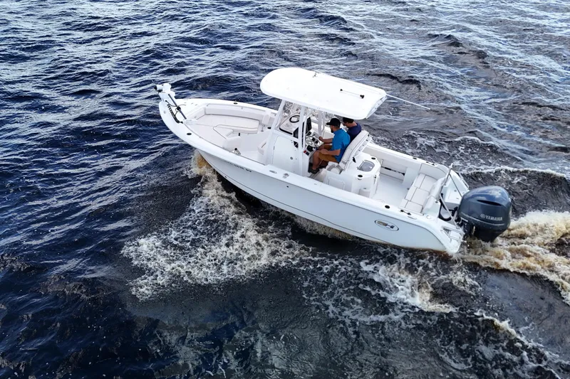 Slide: The Image of 2021 Sea Hunt Ultra 234 boat cruising on open water, aerial view. - 31