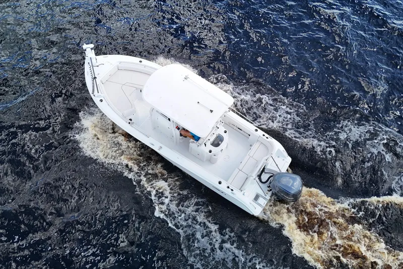 Slide: The Image of Aerial view of 2021 Sea Hunt Ultra 234 boat cruising on water. - 34