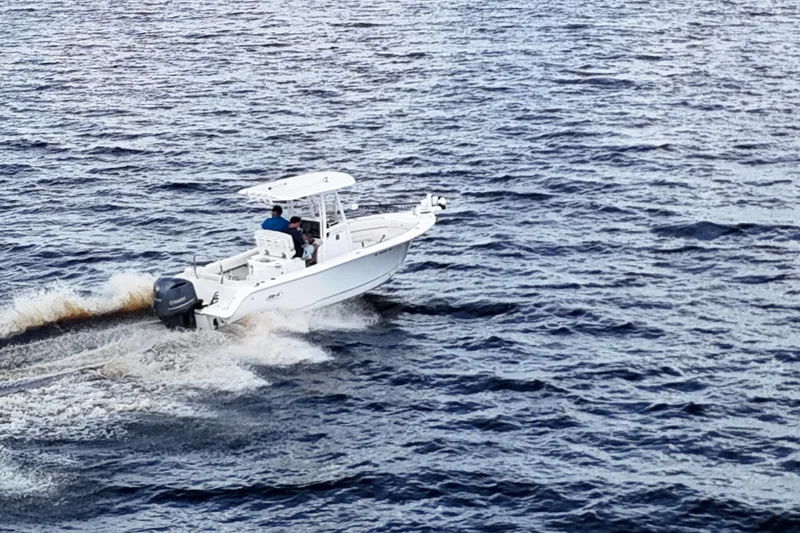 Slide: The Image of 2021 Sea Hunt Ultra 234 boat cruising on open water. - 35