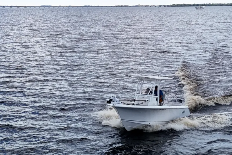 Slide: The Image of 2021 Sea Hunt Ultra 234 boat cruising on open water. - 36