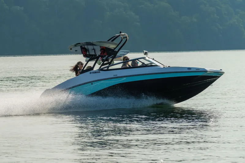 Slide: The Image of Manufacturer Provided Image: 2026 Yamaha AR195 boat speeding on a calm lake with passengers enjoying the ride. - 1