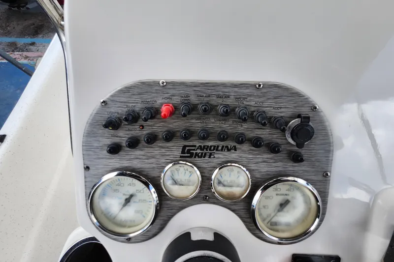 Slide: The Image of Control panel of a 2017 Carolina Skiff 1765 DLX boat with gauges and switches. - 10