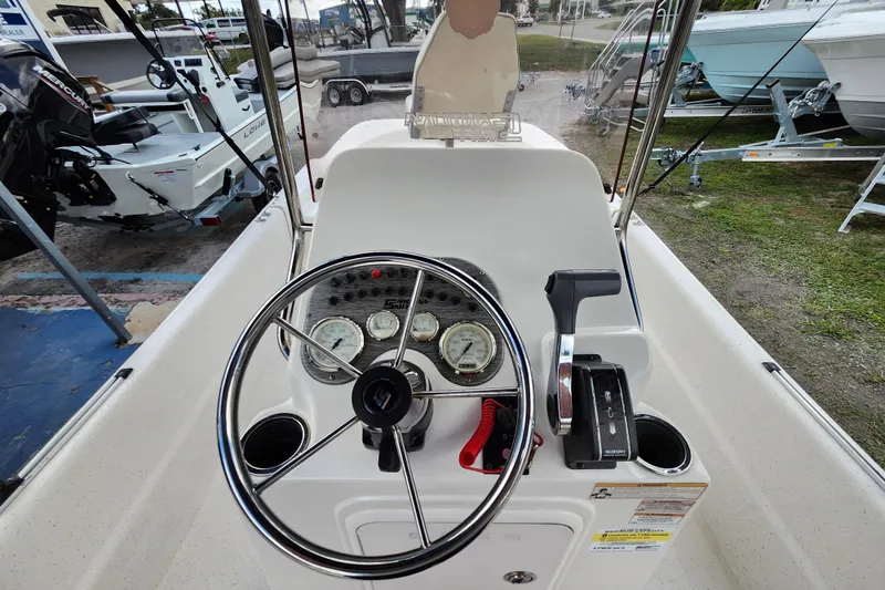 Slide: The Image of 2017 Carolina Skiff 1765 DLX boat console with steering wheel and controls. - 11