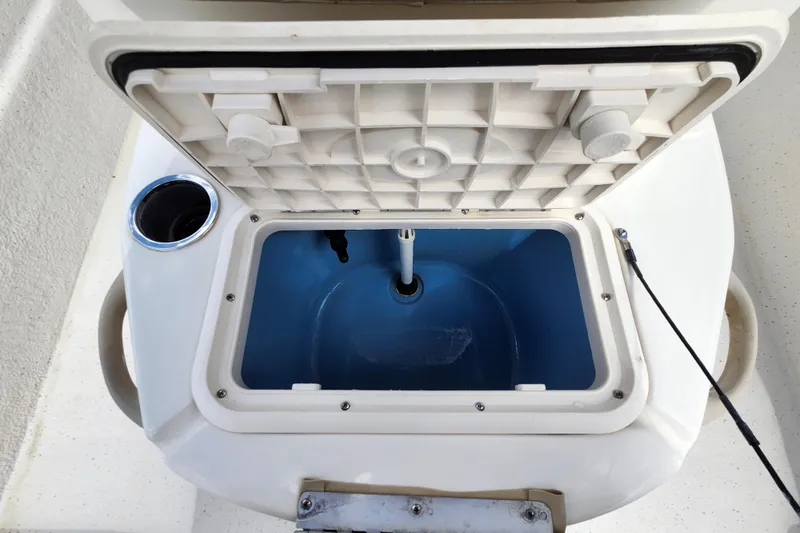 Slide: The Image of Open livewell on 2017 Carolina Skiff 1765 DLX boat, featuring a blue interior. - 12