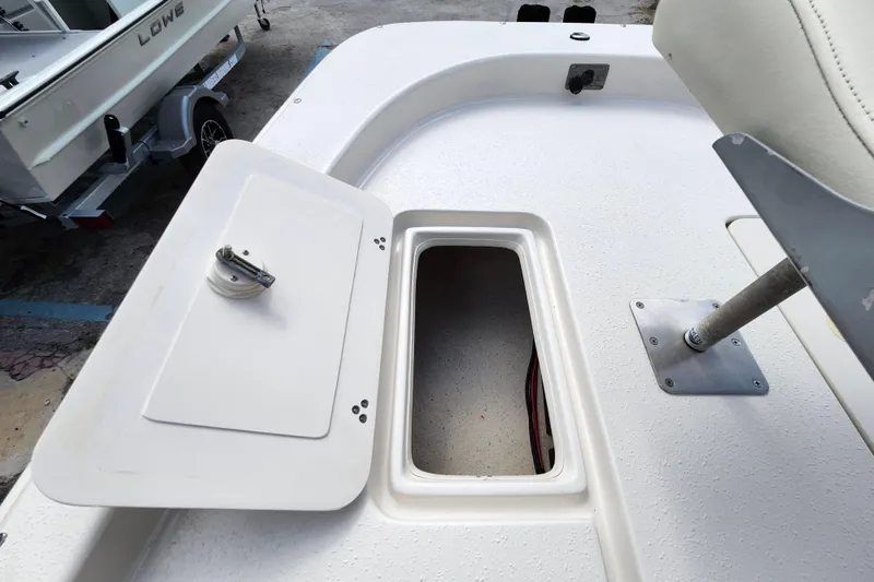 Slide: The Image of 2017 Carolina Skiff 1765 DLX boat storage compartment with open hatch. - 14