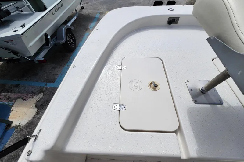 Slide: The Image of 2017 Carolina Skiff 1765 DLX boat deck with storage compartment and seat base. - 16