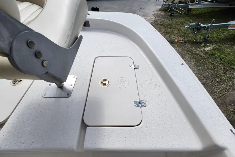 Slide: The Image of 2017 Carolina Skiff 1765 DLX boat deck with storage compartment and seat. - 17