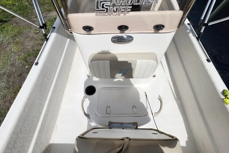 Slide: The Image of 2017 Carolina Skiff 1765 DLX boat interior with seating and console details. - 18