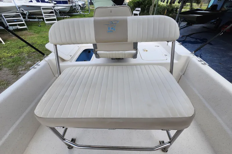 Slide: The Image of 2017 Carolina Skiff 1765 DLX boat seat with white upholstery and metal frame. - 21