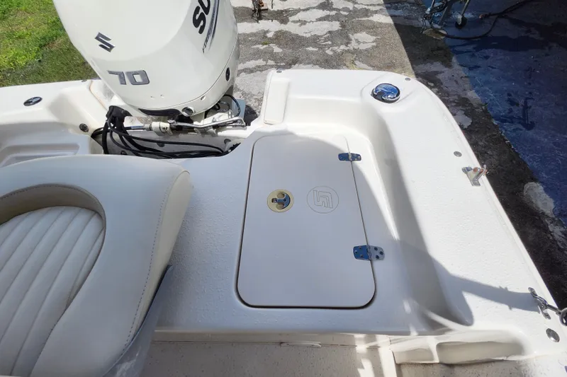 Slide: The Image of 2017 Carolina Skiff 1765 DLX boat with Suzuki 70 engine, rear seating and storage. - 23