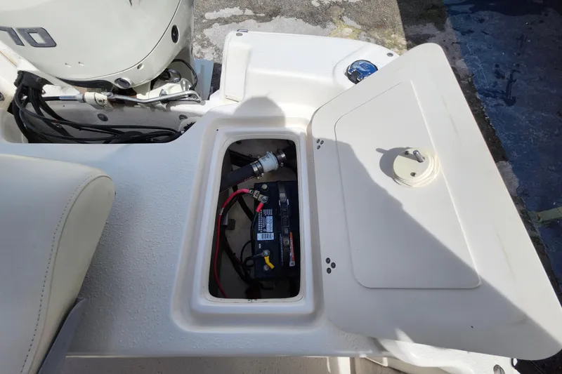Slide: The Image of 2017 Carolina Skiff 1765 DLX boat battery compartment with open hatch. - 24