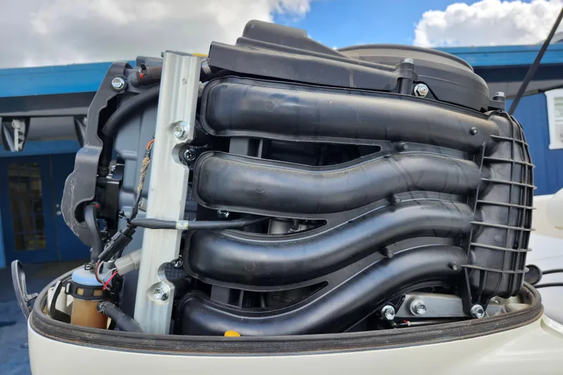 Slide: The Image of Close-up of a 2017 Carolina Skiff 1765 DLX boat engine, showcasing intricate components. - 36