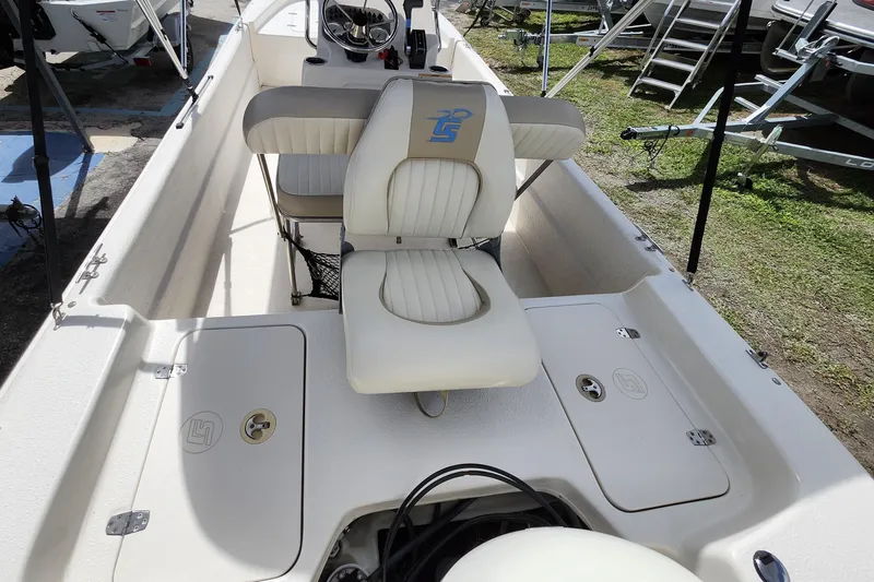 Slide: The Image of 2017 Carolina Skiff 1765 DLX boat interior with seating and storage compartments. - 6
