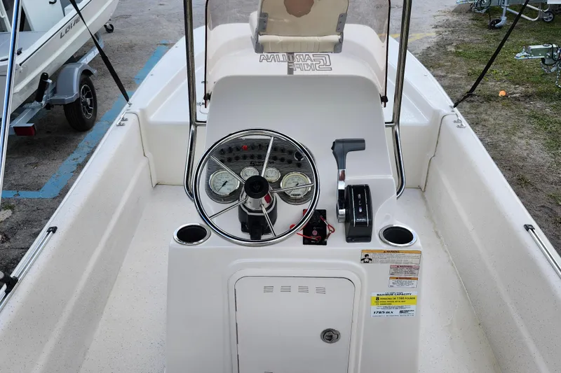 Slide: The Image of 2017 Carolina Skiff 1765 DLX boat console with steering wheel and controls. - 8