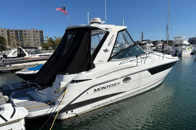 The Image of 2018 Monterey 335 Sport Yacht docked at marina with American flag. - 0