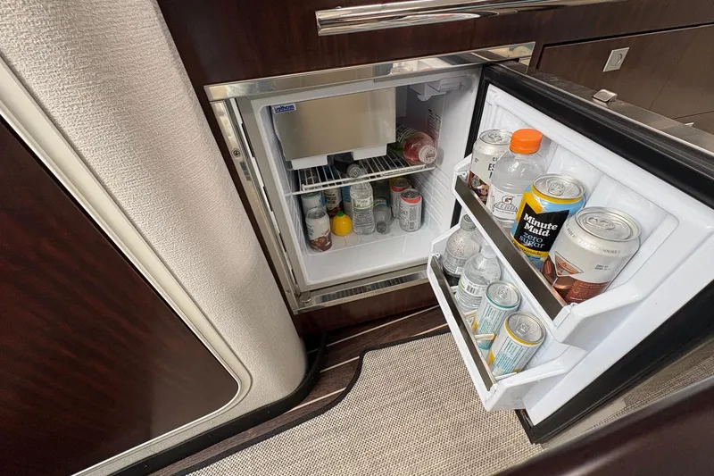 Slide: The Image of Mini fridge stocked with drinks inside a 2018 Monterey 335 Sport Yacht. - 17
