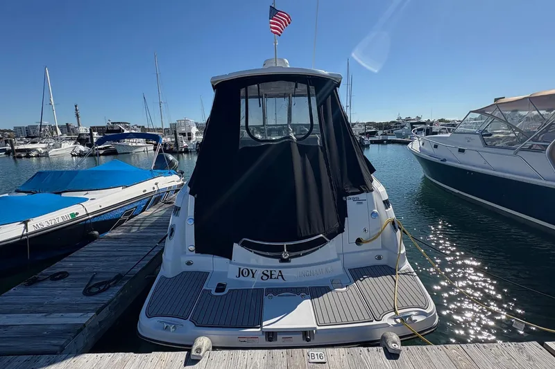 Slide: The Image of 2018 Monterey 335 Sport Yacht docked at marina with American flag. - 2