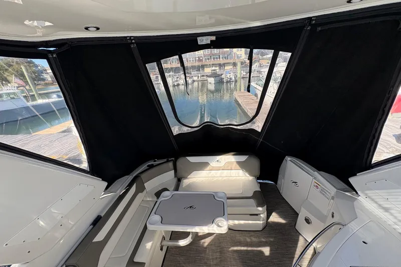 Slide: The Image of 2018 Monterey 335 Sport Yacht interior with seating and table, dock view. - 4