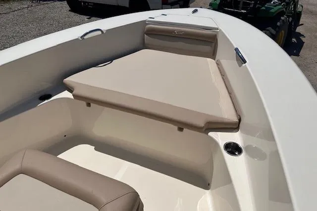 Slide: The Image of 2026 Scout 195 Sportfish boat interior with beige seating and cup holders. - 5