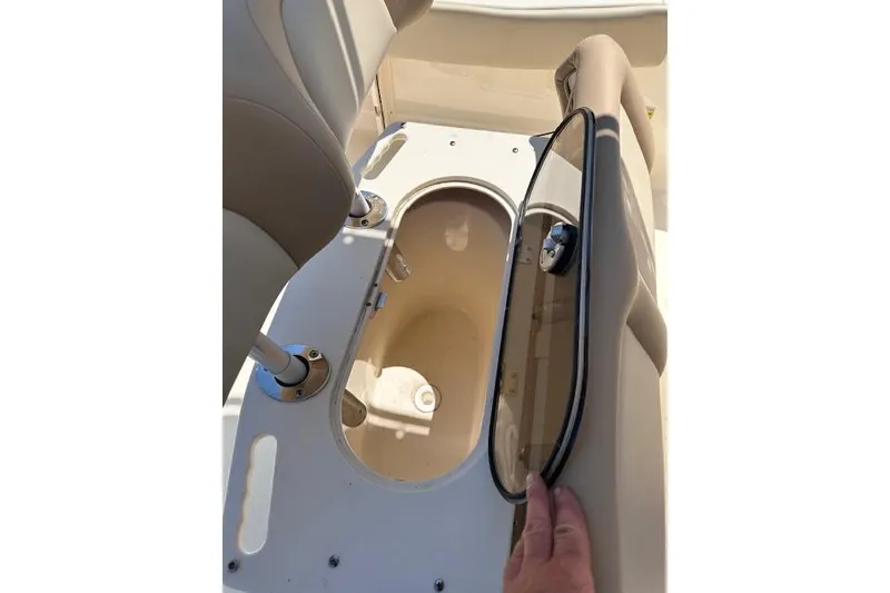 Slide: The Image of 2026 Scout 195 Sportfish boat storage compartment with open lid and seating area. - 6