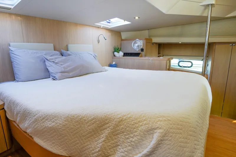 Slide: The Image of Luxurious bedroom interior of 2021 Aquila 44 Yacht with cozy bedding and modern decor. - 14