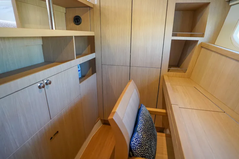 Slide: The Image of Interior of 2021 Aquila 44 Yacht with wooden cabinetry and seating area. - 16