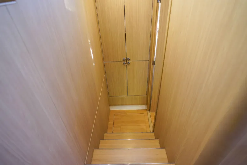 Slide: The Image of Staircase inside 2021 Aquila 44 Yacht with wooden finish and storage cabinets. - 17