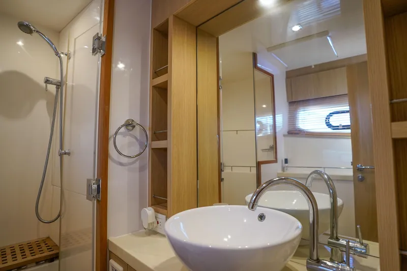 Slide: The Image of Luxurious bathroom in 2021 Aquila 44 Yacht with modern fixtures and wooden accents. - 19