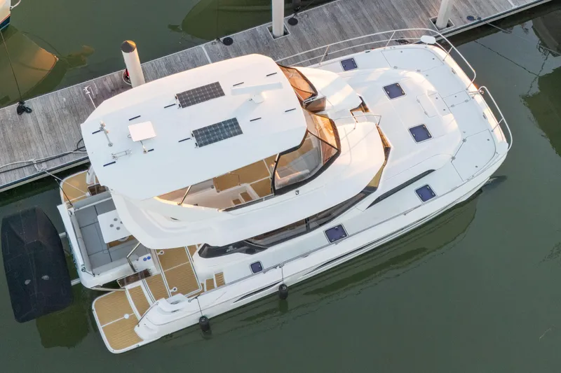 Slide: The Image of Aquila 44 Yacht 2021 docked, aerial view showcasing sleek design and solar panels. - 2