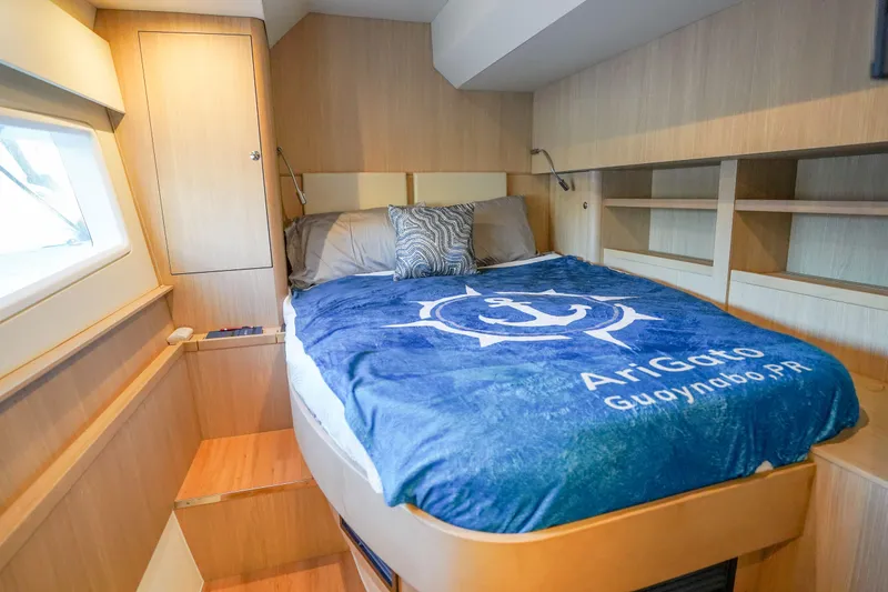 Slide: The Image of Cozy bedroom interior of 2021 Aquila 44 Yacht with nautical-themed bedding. - 21