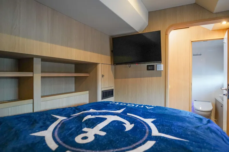 Slide: The Image of Interior of 2021 Aquila 44 Yacht cabin with TV and ensuite bathroom. - 22