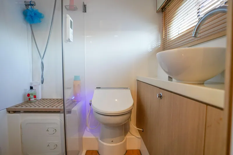 Slide: The Image of Modern bathroom on 2021 Aquila 44 Yacht with toilet, sink, and shower. - 23