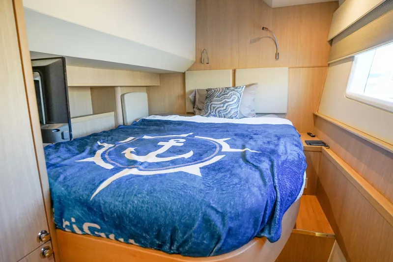 Slide: The Image of Cozy bedroom in 2021 Aquila 44 Yacht with nautical-themed bedding and modern design. - 24