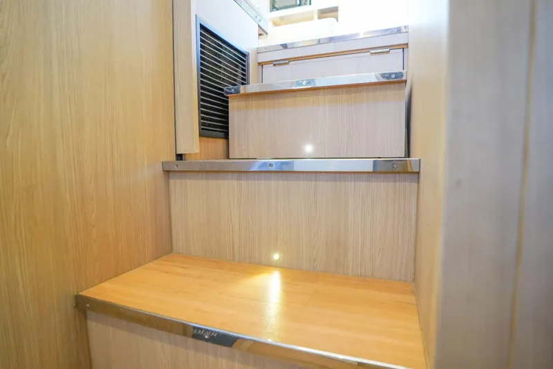 Slide: The Image of Wooden staircase inside 2021 Aquila 44 Yacht, featuring sleek metal accents. - 25