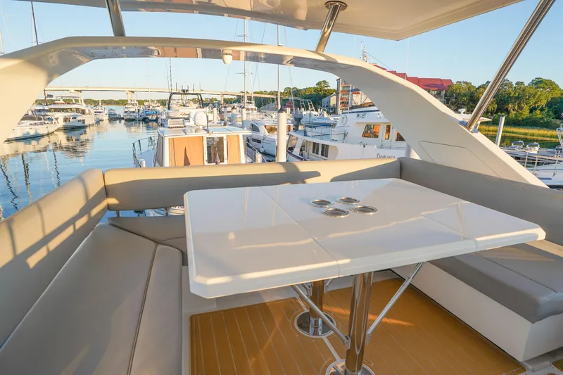 Slide: The Image of Luxurious seating area on 2021 Aquila 44 Yacht, docked at a scenic marina. - 36