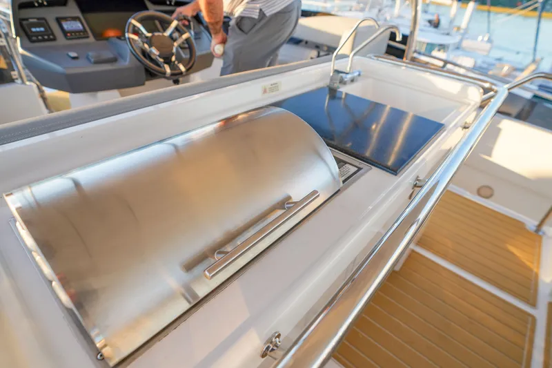 Slide: The Image of Outdoor kitchen on 2021 Aquila 44 Yacht with grill and sink, near helm station. - 38