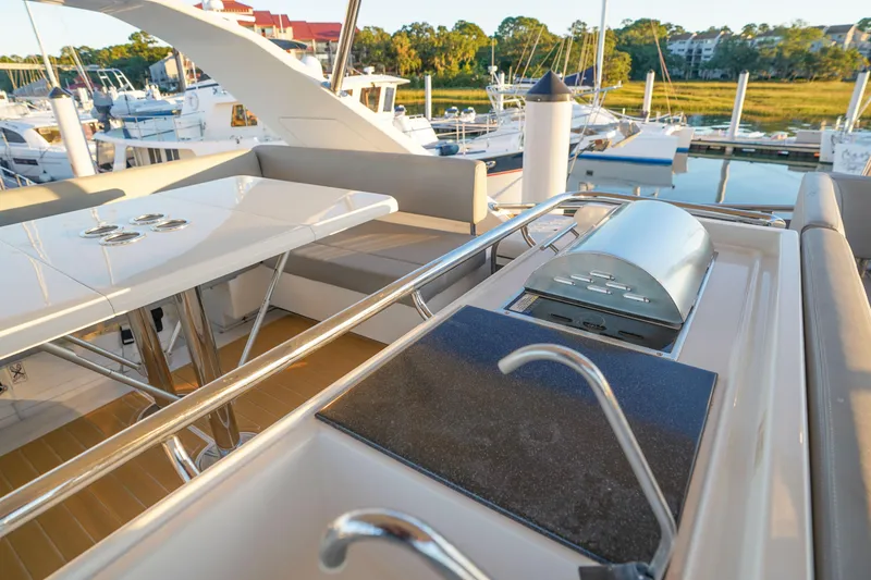 Slide: The Image of Luxurious 2021 Aquila 44 Yacht deck with dining area and grill, docked at marina. - 39