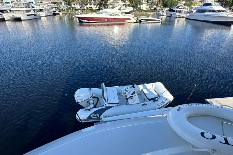 Slide: The Image of Aquila 44 Yacht 2021 docked with inflatable boat on calm marina waters. - 4