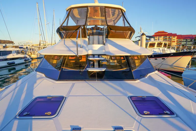 Slide: The Image of 2021 Aquila 44 Yacht docked in marina, showcasing sleek design and modern features. - 51