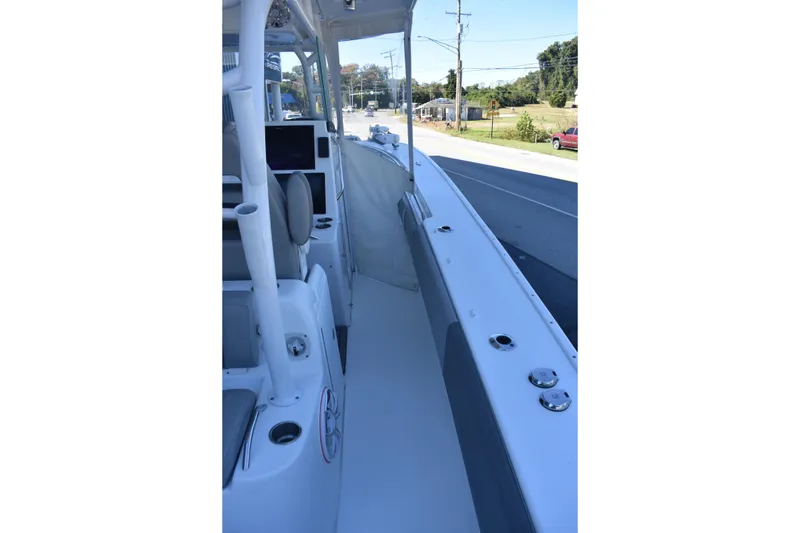 Slide: The Image of 2021 Cape Horn 36 XS boat interior with seating and console, docked near a road. - 26