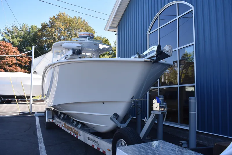Slide: The Image of 2021 Cape Horn 36 XS boat on trailer outside blue building. - 4