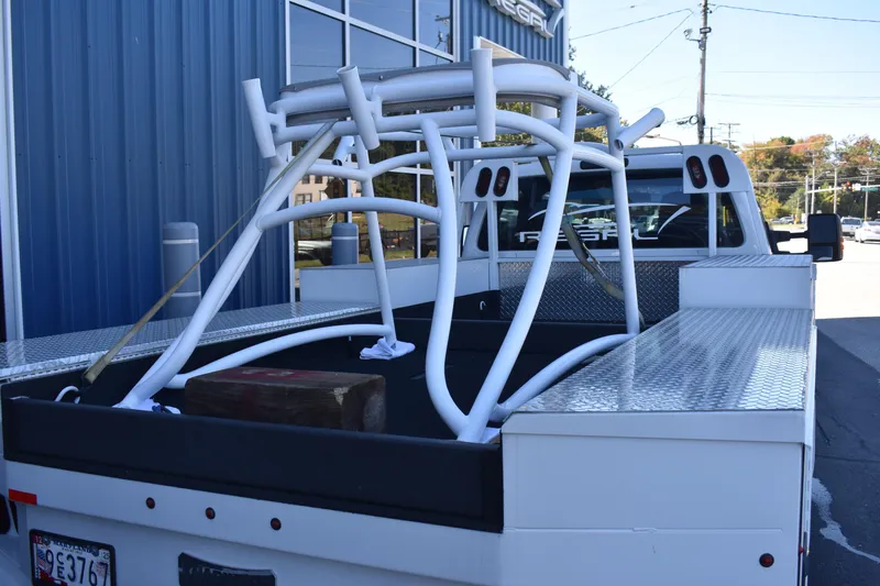 Slide: The Image of White Cape Horn 36 XS frame on truck bed, parked outside a building. - 7