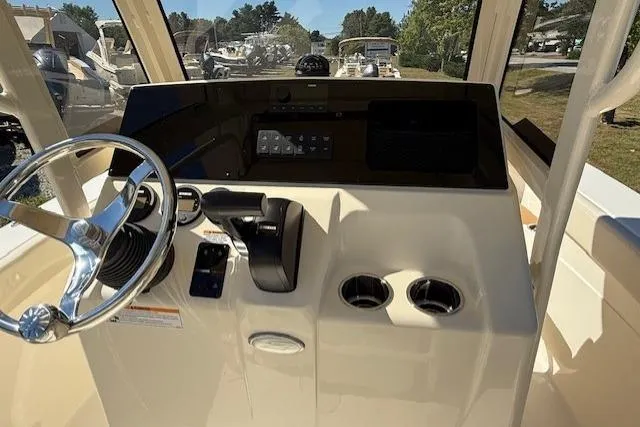 Slide: The Image of 2026 Scout 215 XSF boat dashboard with steering wheel and controls. - 2