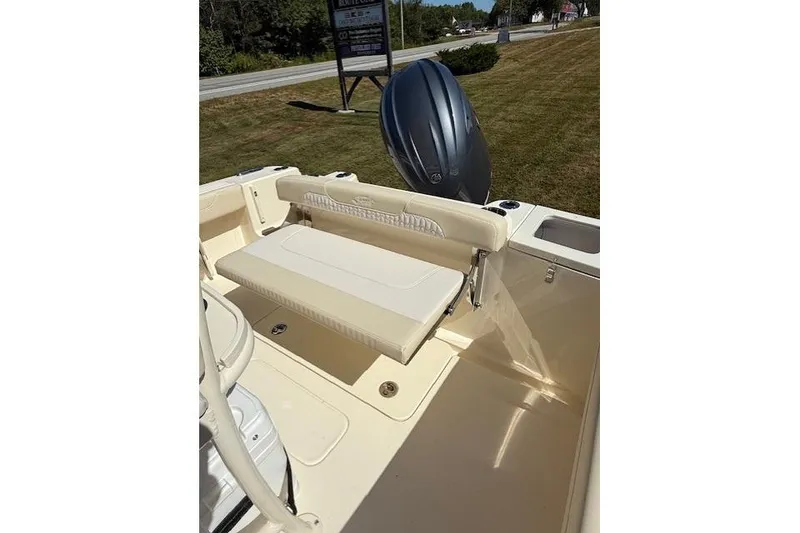 Slide: The Image of 2026 Scout 215 XSF boat interior with seating and outboard motor. - 3