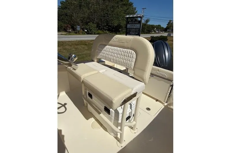 Slide: The Image of 2026 Scout 215 XSF boat interior with beige seating and storage compartment. - 4