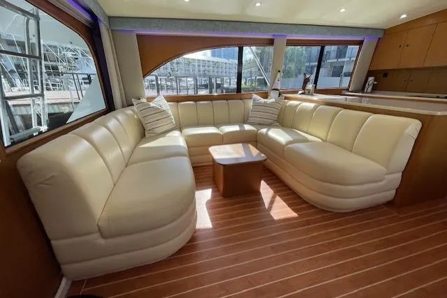 Slide: The Image of Luxurious interior of 2003 Post Flybridge Convertible yacht with plush seating and wooden flooring. - 10