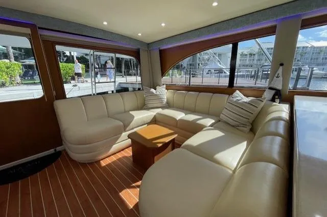 Slide: The Image of Luxurious interior of a 2003 Post Flybridge Convertible yacht with plush seating and wooden flooring. - 11