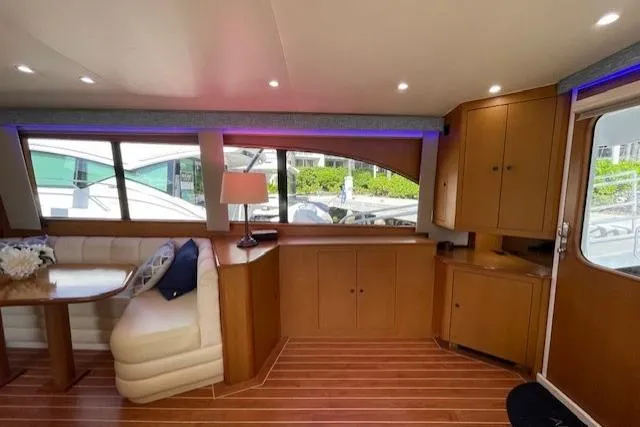 Slide: The Image of Luxurious 2003 Post Flybridge Convertible yacht interior with wood flooring and elegant seating. - 13